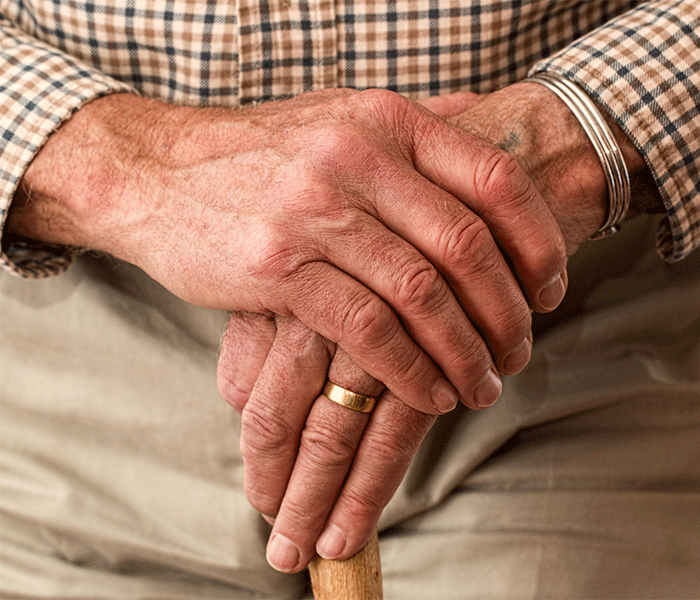 close up shot of senior's hands with wedding band